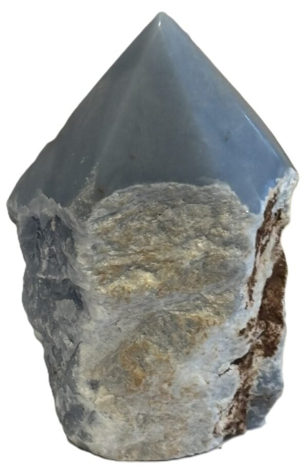 Natural rough angelite freeform with polished point 3 sians emporium Natural rough angelite freeform crystal with unpolished sides and a smooth polished blue point standing on a white background